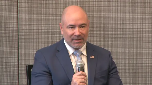 A man holds a microphone.