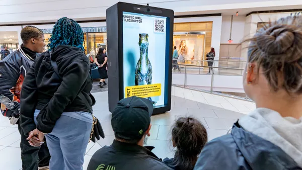 Mall shoppers engaging with a hologram device by Proto