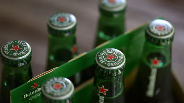 A close up of a six pack of Heineken beer bottles.
