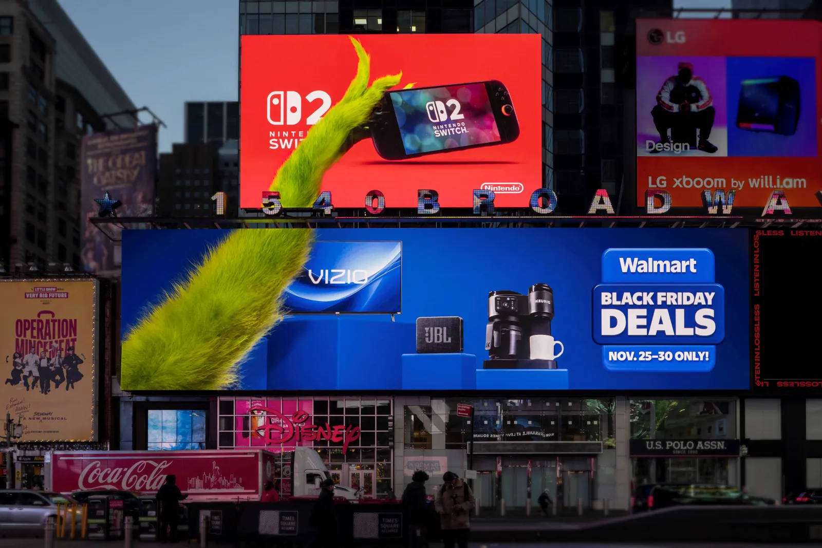Times Square billboards for Walmart show the Grinch's arm showcasing products like a Nintendo Switch 2