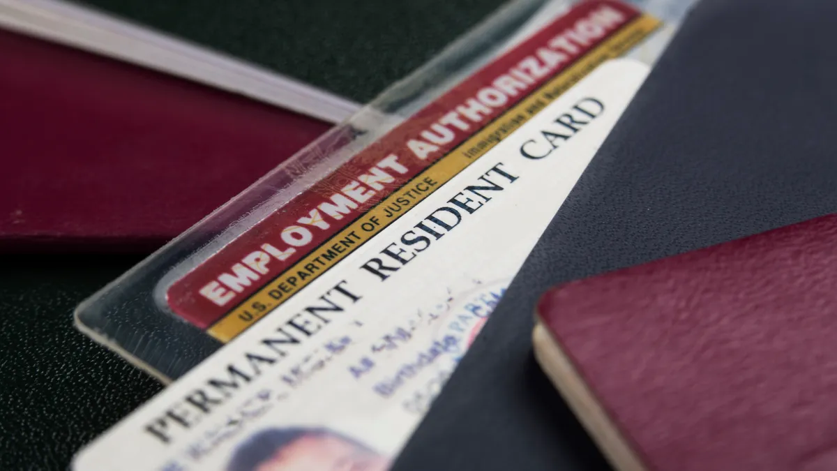 A U.S. permanent resident card and employment authorization card are displayed.