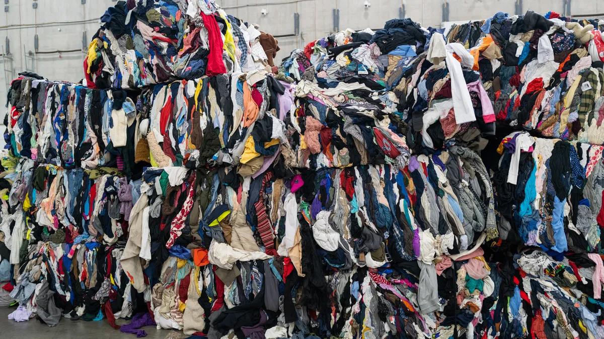 Piles of unsold multi-colored clothing in a large heap