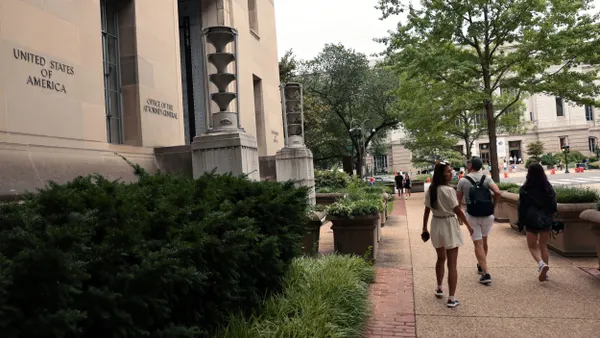 Individuals walk past the U.S. Department of Justice building.
