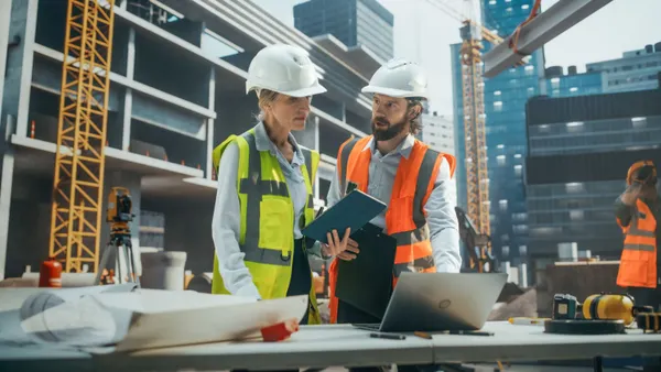 A pair of construction workers on a jobsite.
