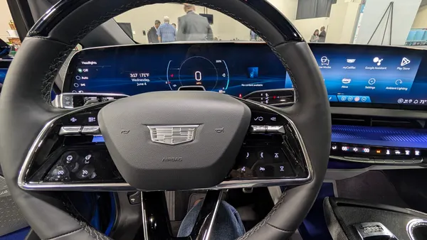 The steering wheel and dashboard of a 2025 Cadillac Lyriq SUV.