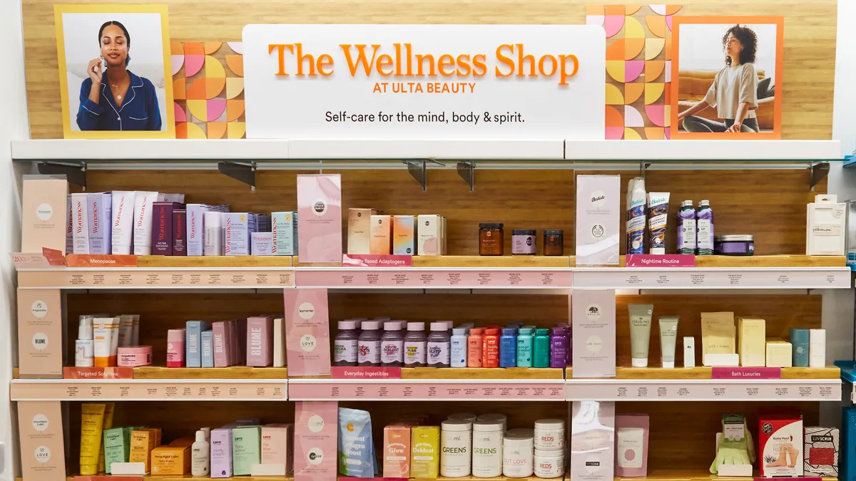 Shelves with consumer products, with a sign above that reads "The Wellness Shop."