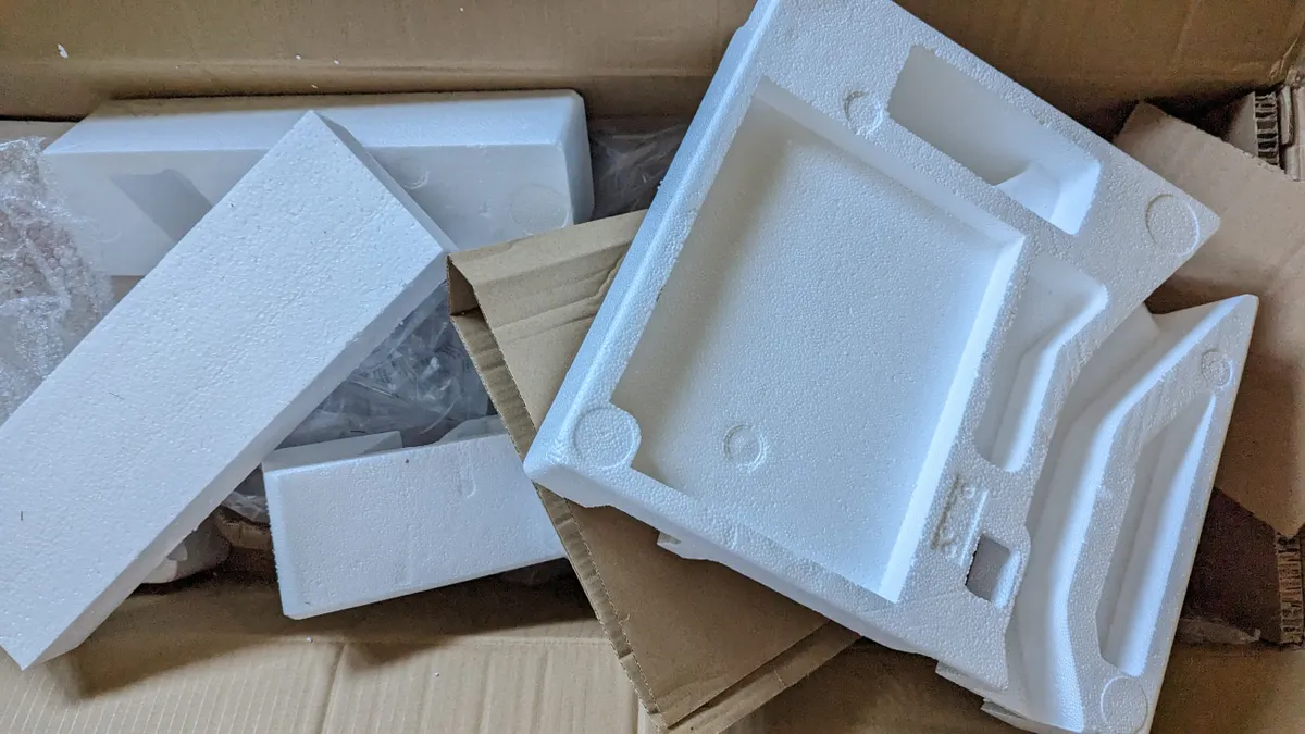 A variety of packaging, including expanded polystyrene foam next to cardboard boxes.