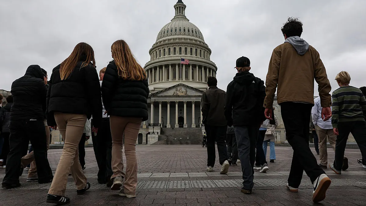 A group of people are walking toward the outside of the U.S. Capitol building in Washington, D.C.