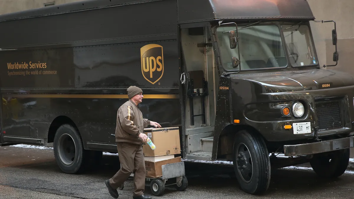 A UPS worker delivers packages on December 26, 2013 in Chicago, Illinois.