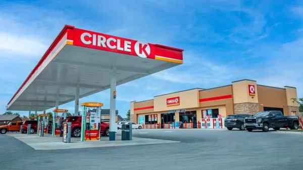 A photo of the exterior of a gas station and convenience store. Signs on the pumps, store and canopy say "Circle K."