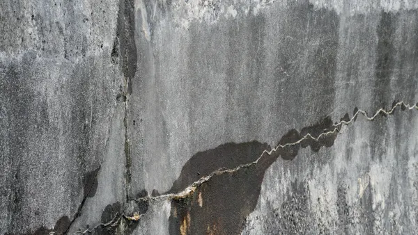 A crack in a concrete retaining wall.