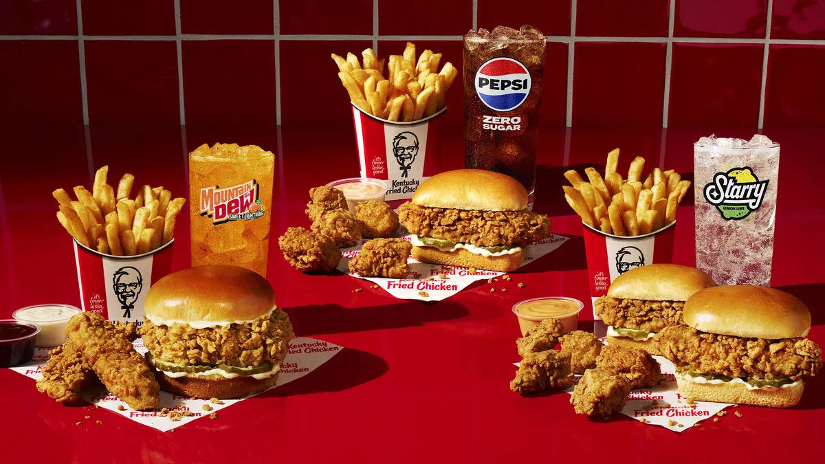 A spread of KFC items including sandwiches, snackers, nuggets, fries and drinks.