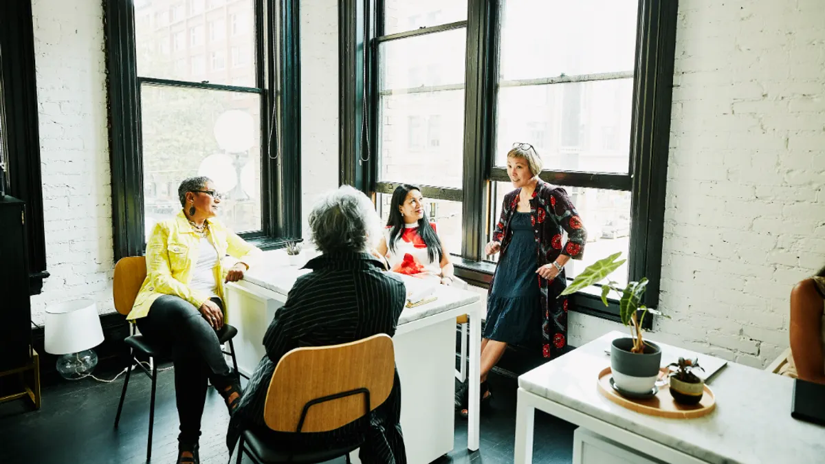 Businesswomen in discussion at desk in office