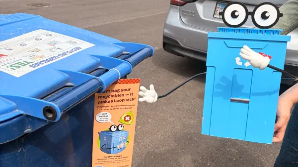 Loop, a recycling cart mascot, is displayed on the street