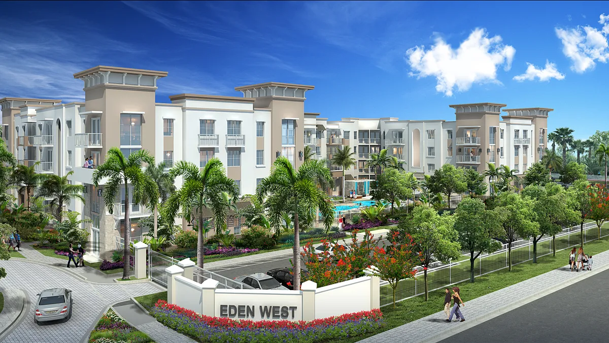 Tan apartment building with palm trees in the foreground.