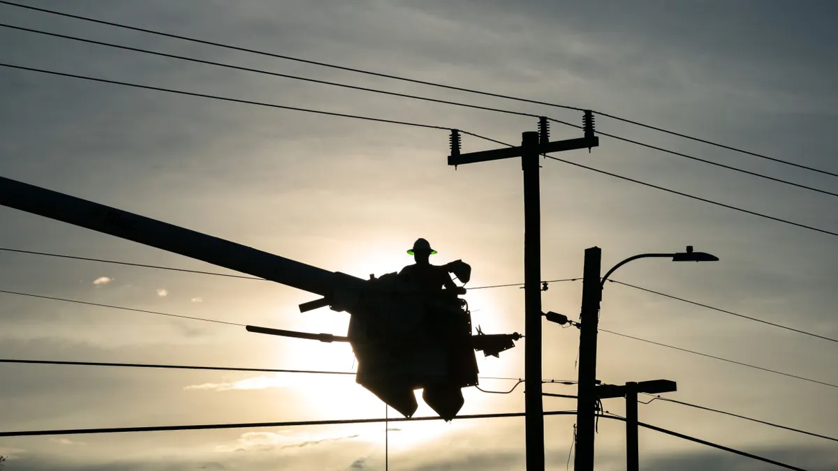 A lineman works on a power line.
