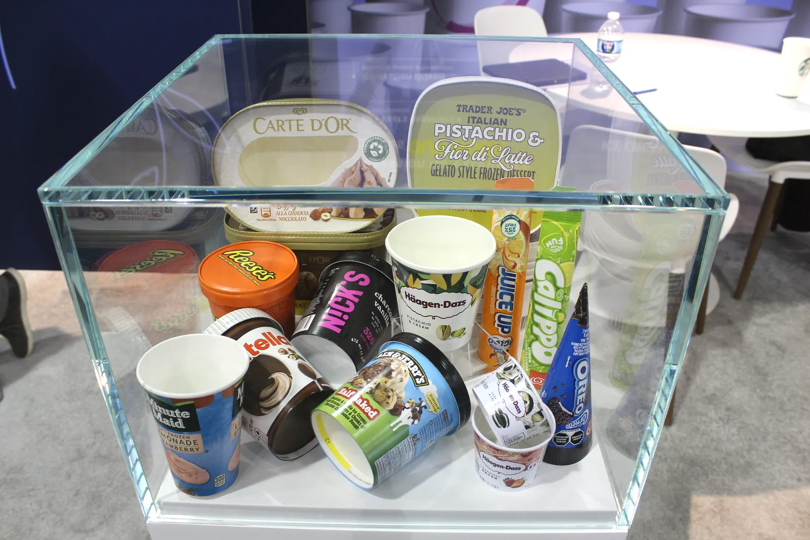 A display at a trade show containing various fiber-based packaging solutions for ice cream.