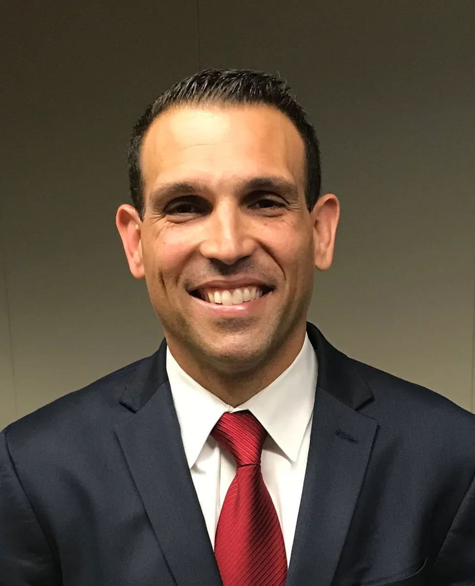 Profile picture of man wearing a suit and tie