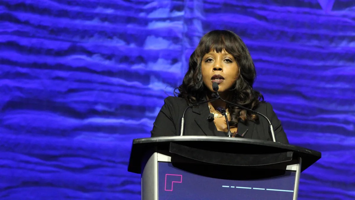 A person speaks at a podium.