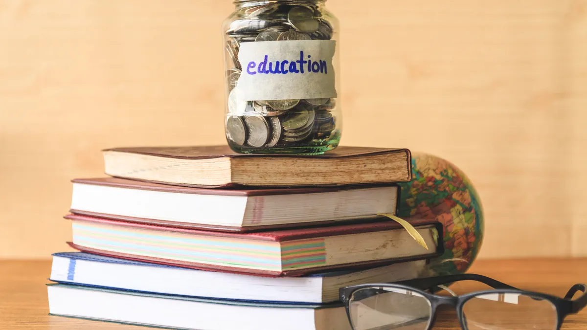 Clear change bank; on tops of books