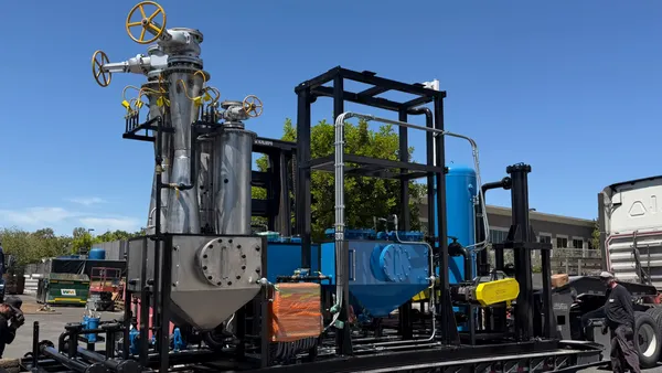 A large flatbed truck hauls manufacturing equipment