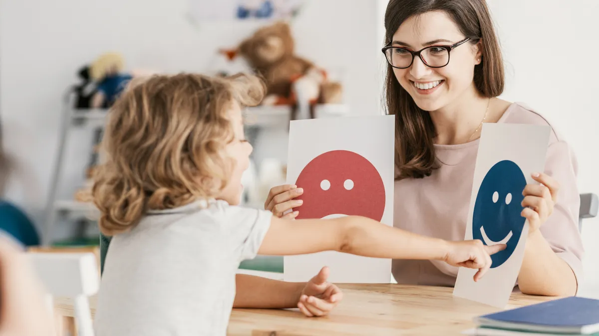 Emotion emoticons used by a psychologist during a therapy session with a child with an autism spectrum disorder.