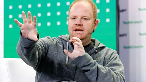 Rippling Co-founder and CEO Parker Conrad speaks onstage at a conference.