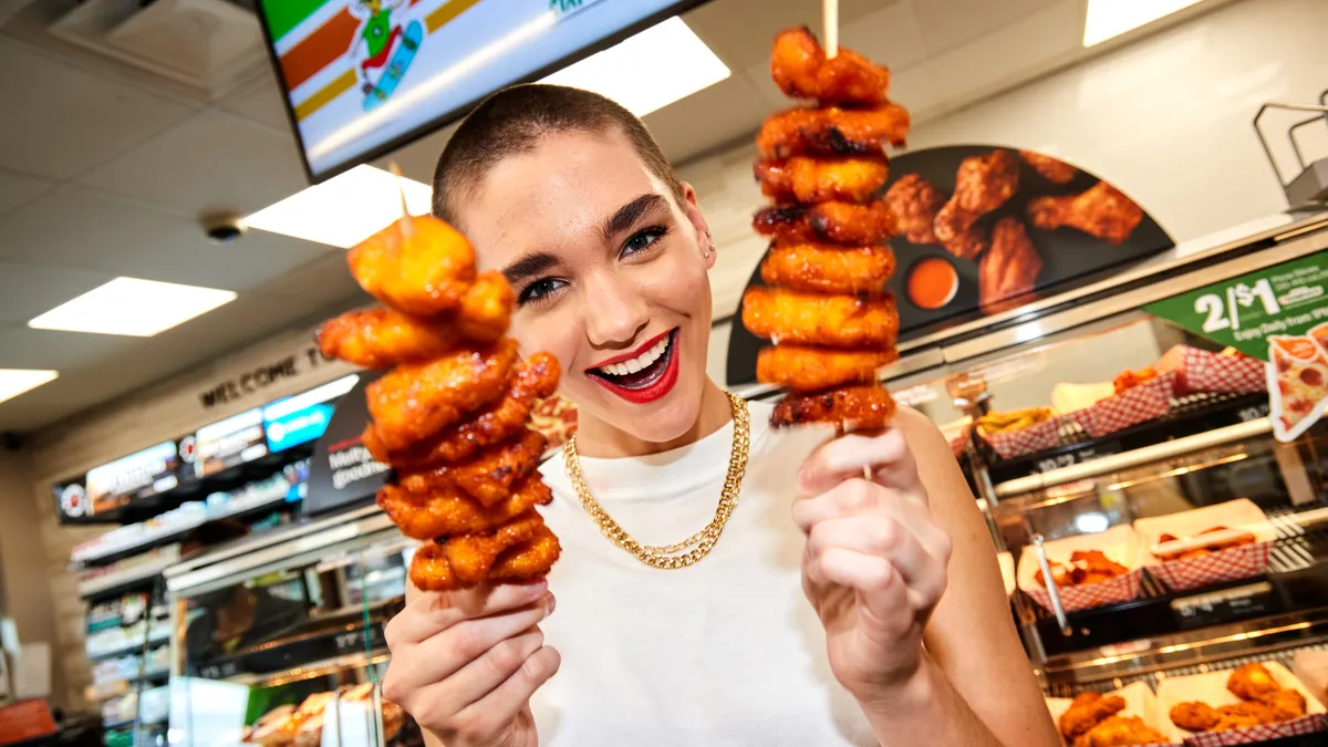 A photo of a person holding food from a 7-Eleven.