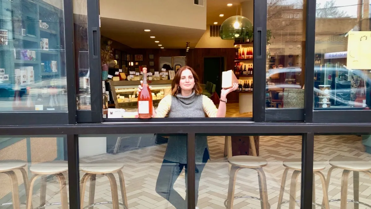 All Together Now owner Erin Weber at her restaurant's pickup window during the novel coronavirus pandemic.