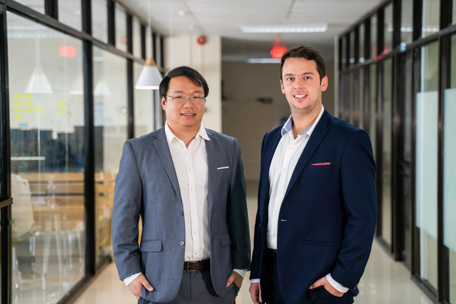 Two men in suits standing.