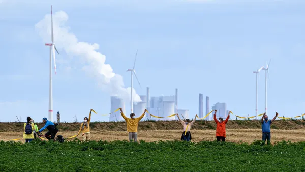 People seen protesting in front of a factory.