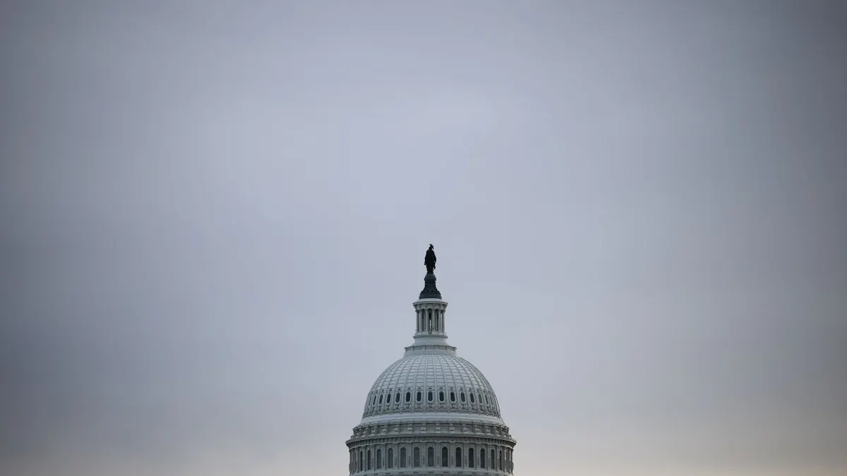 The top of the U.S. Capitol Building's dome is pictured on a cloudy day.