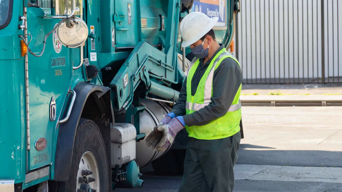 Los Angeles Sanitation and Environment driver outside of collection truck