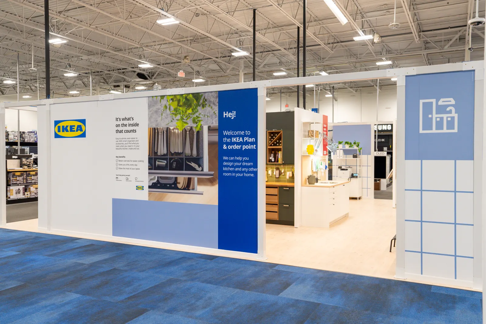 A blue and white Ikea shop-in-shop inside of a Best Buy storefront.