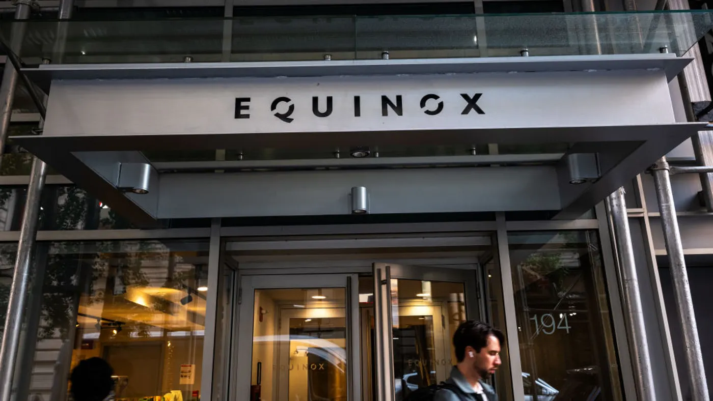 Pedestrians walk past Equinox fitness club center in New York City