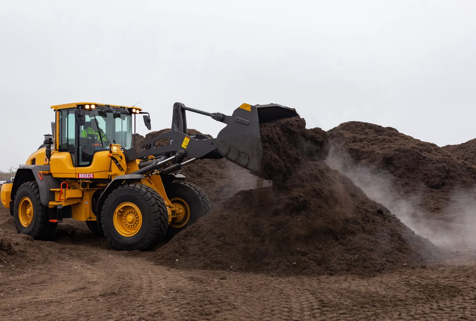 Agromin tractor moving compost in California