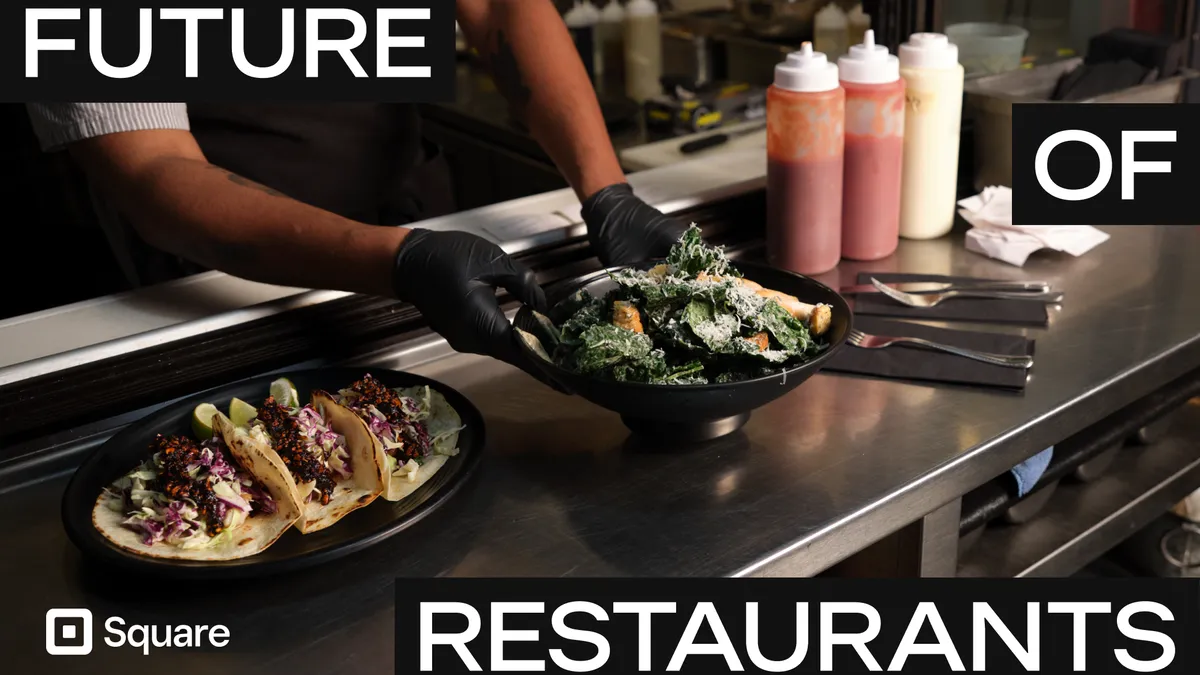 An image of a bowl of salad being served right next to a plate of tacos.