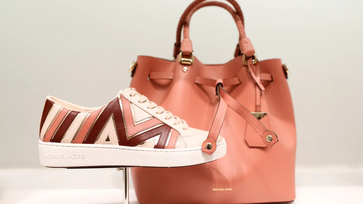 Michael Kors shoes and a bag are pictured in a store display.