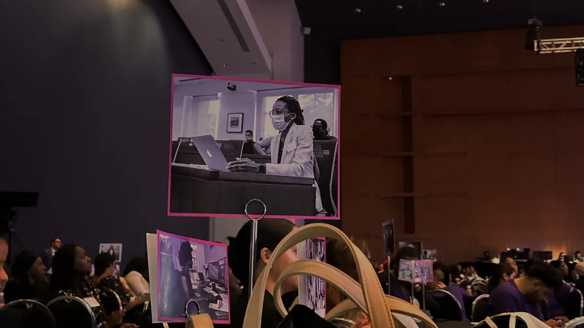 An image of a laminated card, featuring a working woman, on the table