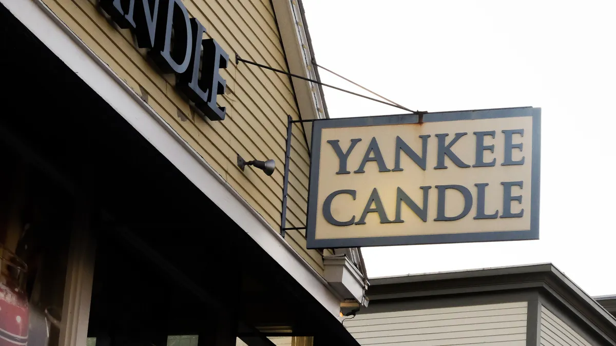 White store sign saying Yankee Candle in black letters