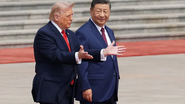 Two men walk side-by-side with steps visual in the background.
