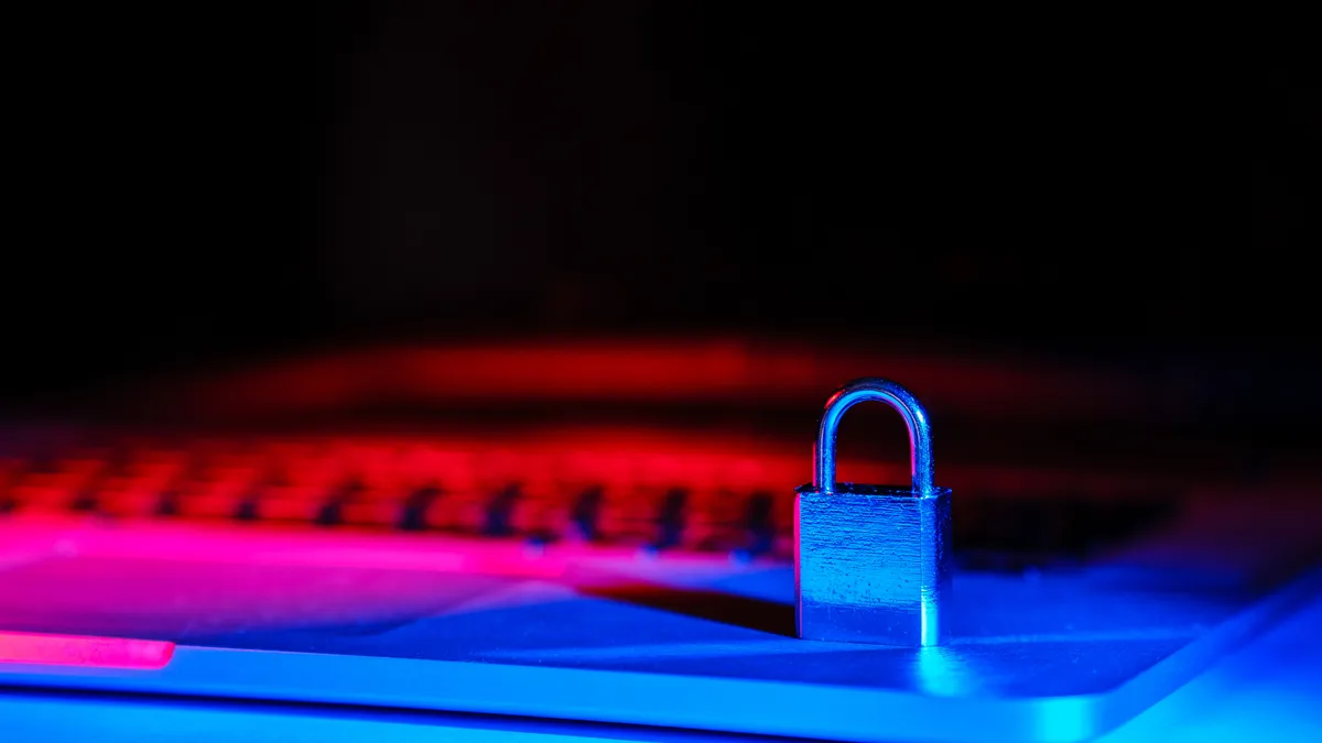 A tiny padlock on top of a laptop keyboard