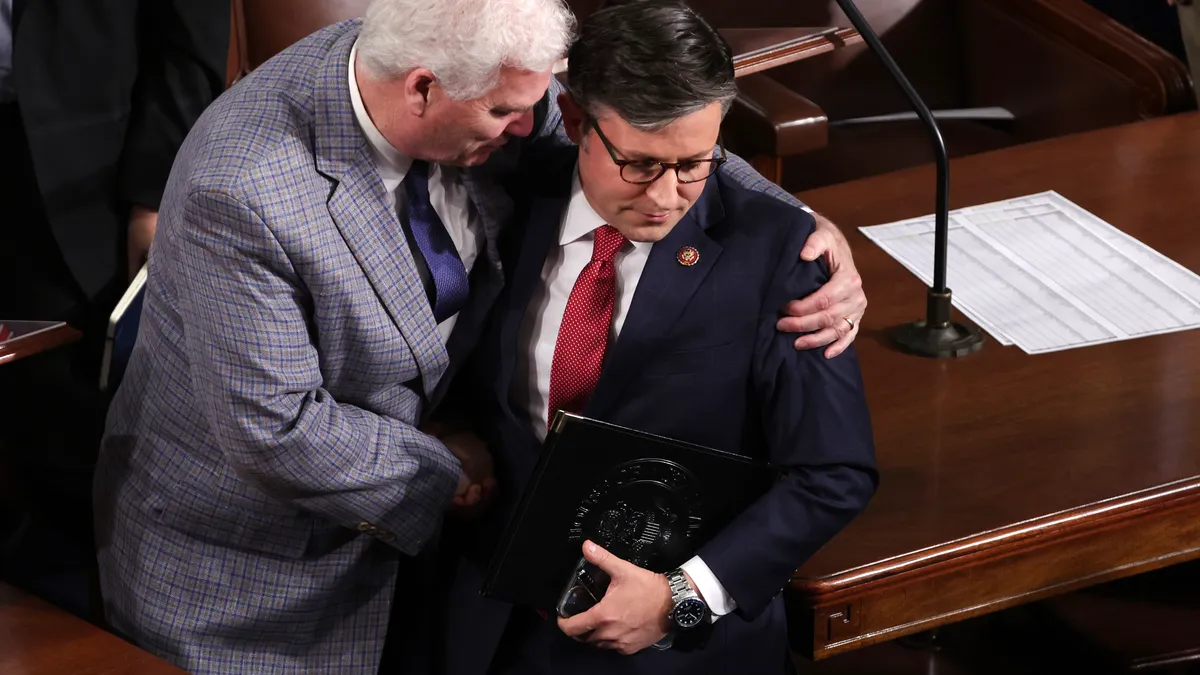 Two men hug on the floor of the U.S. Capitol