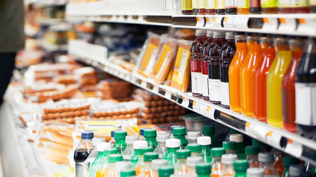 Packaged items on refrigerated grocery shelves.