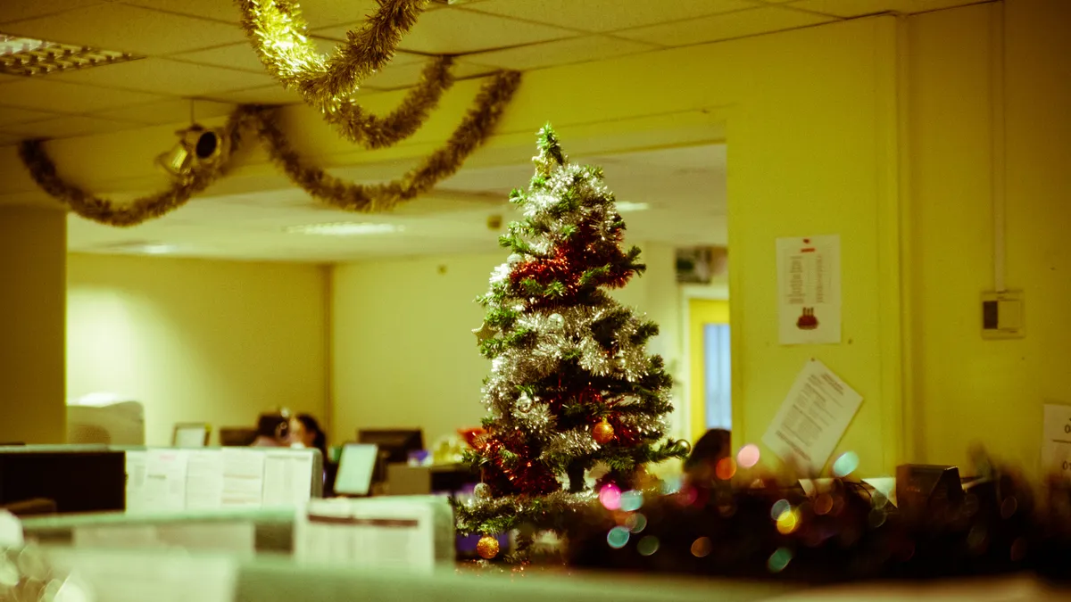 A lomography style photo of a Christmas tree in an outdated fluorescent-lit building