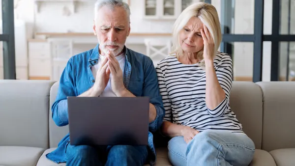 two people sitting on couch