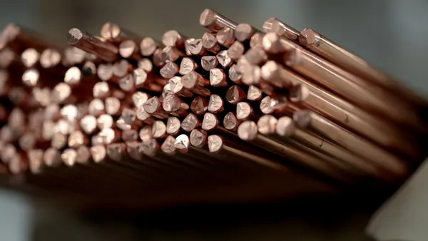 Copper rods stacked on a shelf