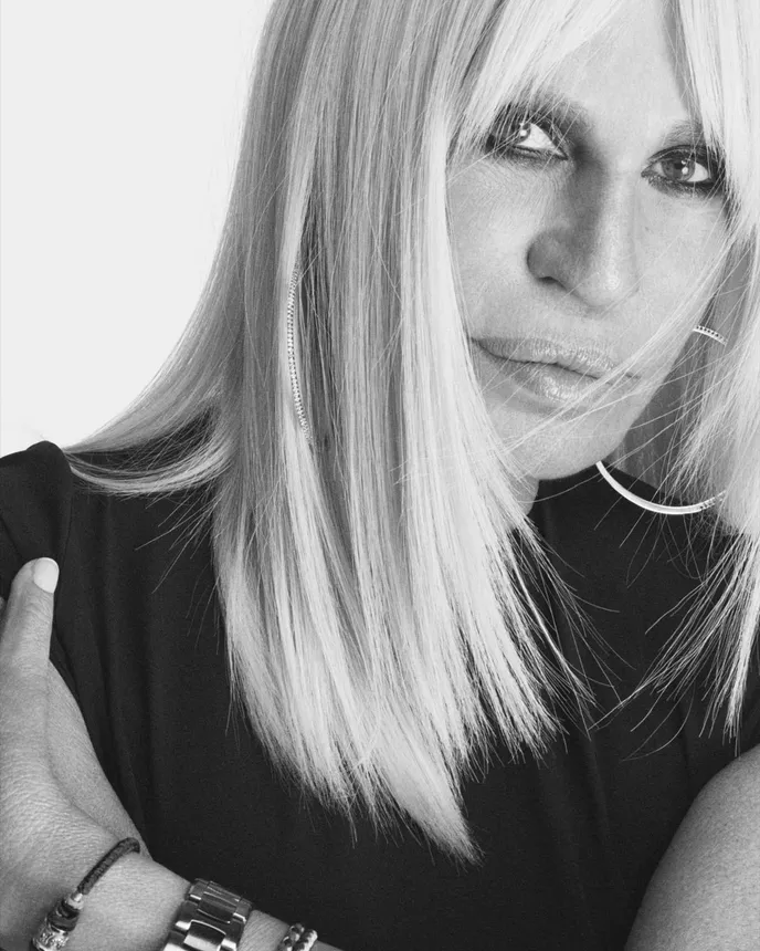 A headshot of Donatella Versace in black and white