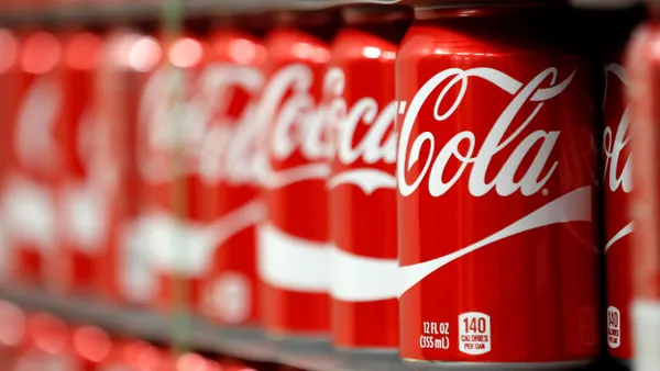 Coca-Cola cans on a pallet.
