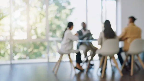 a blurred image of a boardroom